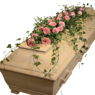 En kista av ljust trä dekorerad med rosa rosor och grönska.